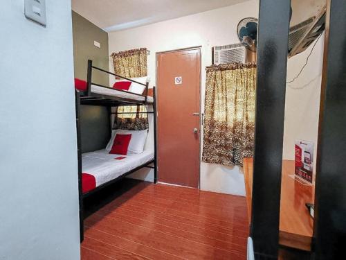 a small room with a bunk bed and a door at RedDoorz near KCC Mall Gensan in General Santos