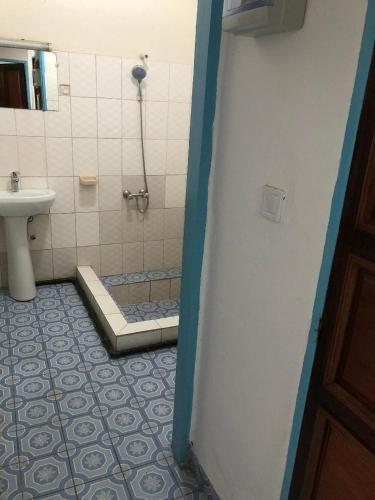 a bathroom with a shower and a toilet and a sink at OCEAN-SI Mansion in Kribi