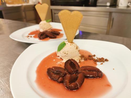 two plates of food with ice cream on a table at Landgasthof Büttel in Geisfeld