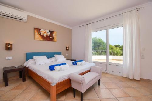 a bedroom with a large bed and a window at Anngo in Jávea