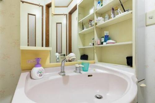 a bathroom with a white sink and a mirror at Noriko's Home - Vacation STAY 8643 in Kawasaki