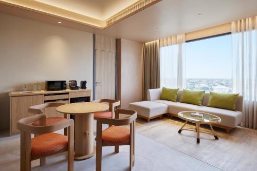 a living room with a couch and a table at Centara Korat in Nakhon Ratchasima