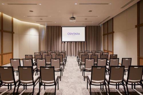 a conference room with chairs and a projection screen at Centara Korat in Nakhon Ratchasima