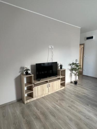 a living room with a flat screen tv on a entertainment center at Villa Balifornia in Balatonboglár