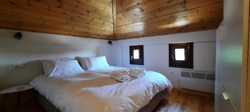 a bedroom with a bed with two stuffed animals on it at Kastania Villas- Villa K3 in Pouríon