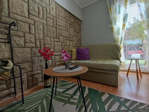 a living room with a couch and a table at Privatni Smeštaj Tešević in Zlatibor