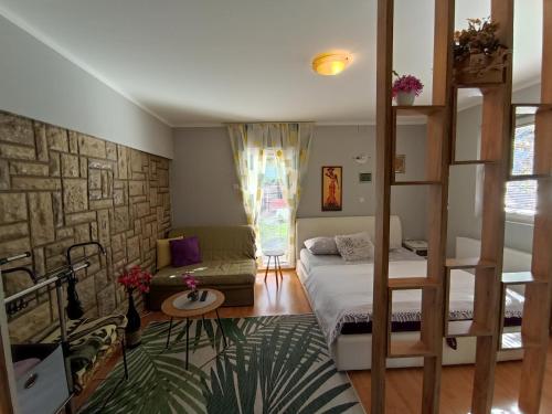 a bedroom with a bunk bed and a couch at Privatni Smeštaj Tešević in Zlatibor