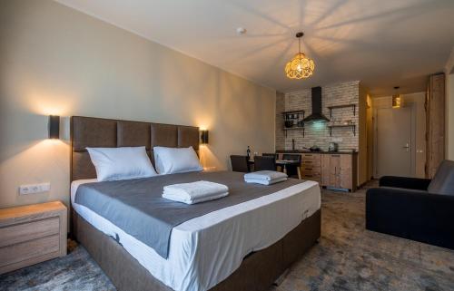 a bedroom with a large bed and a living room at New Gudauri Atrium apartment #233 in Gudauri