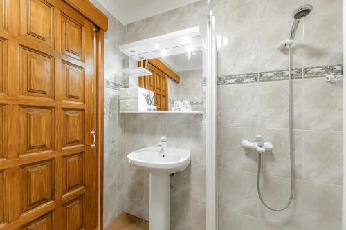 a bathroom with a sink and a shower at Tenerifeopenhome bright penthouse on the beach Los Cristianos in Arona