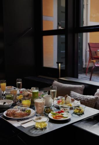 a table topped with plates of food and drinks at Hotel Danmark in Copenhagen