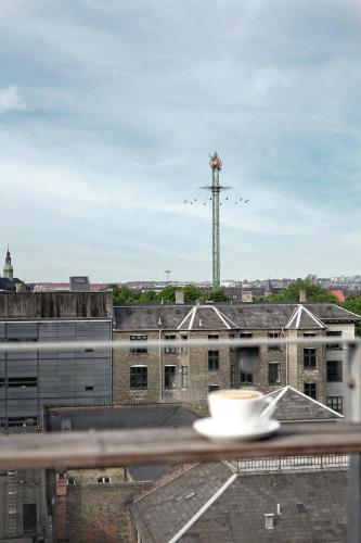 a view of a city with a windmill in the background at Hotel Danmark in Copenhagen