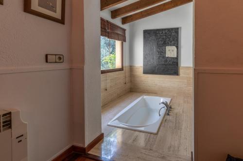 a bathroom with a bath tub in a room at Villa Mireia in Pollença