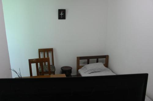 a room with a table and two chairs and a bed at OCEAN-SI Mansion in Kribi