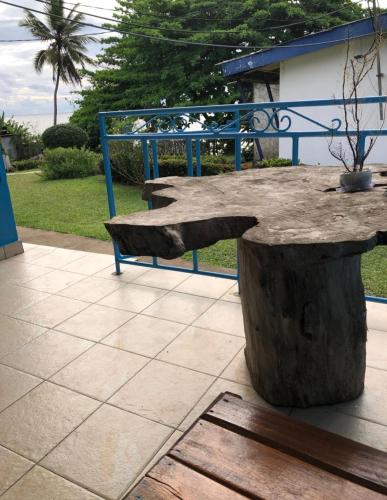 a table made out of a tree stump at OCEAN-SI Mansion in Kribi