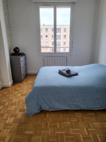 a bedroom with a bed and a large window at Appartement…LH center / 6 pers. parking privé in Le Havre