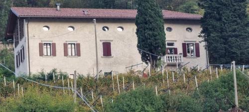 a large house with red windows on a hill at Maso kreuzberg- Monolocale 3- vista montagne in Trento