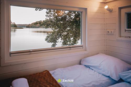 a bed in a small room with a window at Półwysep Zacisze - Tiny House Village in Przywidz
