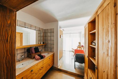 a bathroom with a tub and a sink and a mirror at Waldjuwel Mostviertel in Allhartsberg