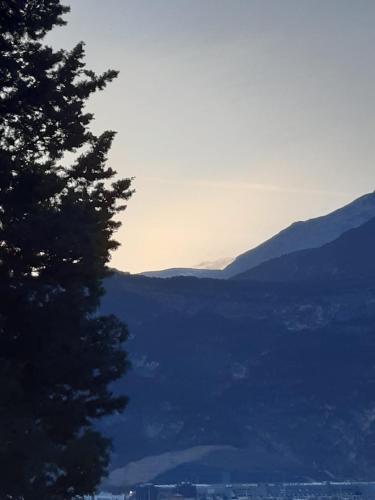 a view of a mountain range with a tree at Maso kreuzberg- Monolocale 3- vista montagne in Trento