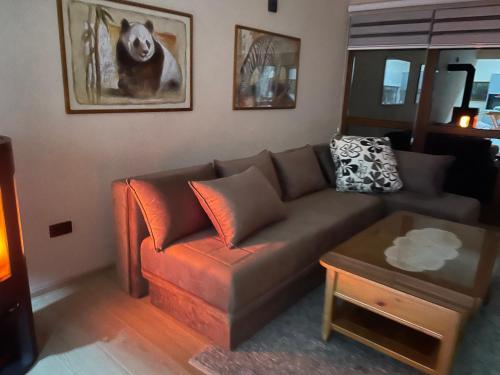 a living room with a brown couch and a table at Josanica Bed&Breakfast in Konjic