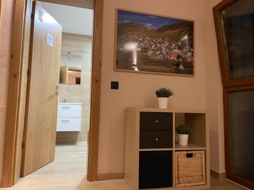 a hallway with a door leading into a room with a painting on the wall at Josanica Bed&Breakfast in Konjic