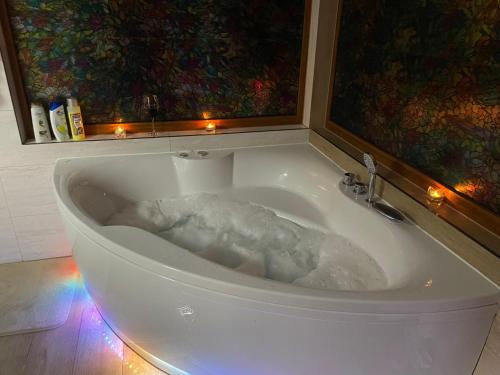 a bath tub filled with lots of foam in a room at Josanica Bed&Breakfast in Konjic