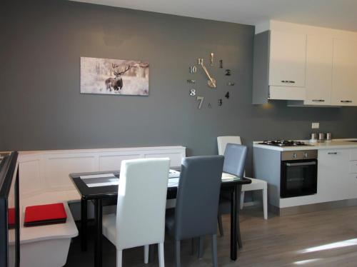 a kitchen and dining room with a table and chairs at CASA 4 PIOPPI - Agenzia Dolomiti Affitti in Cavalese