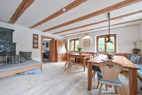 a kitchen and dining room with a wooden table and chairs at Exklusives und Modernes Bauernhaus in Nesselwang