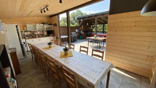 a kitchen and dining room with a table and chairs at Evin*raj in Kvačany