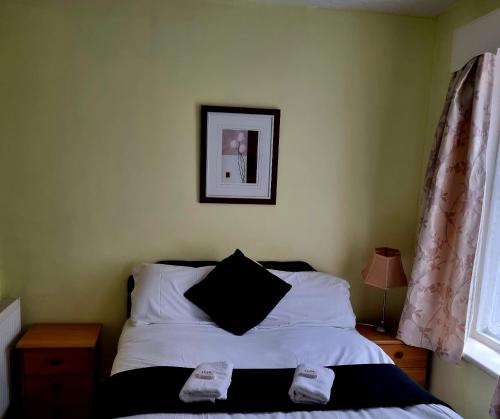 a bedroom with a bed and a picture on the wall at The New Osterley Hotel in Blackpool
