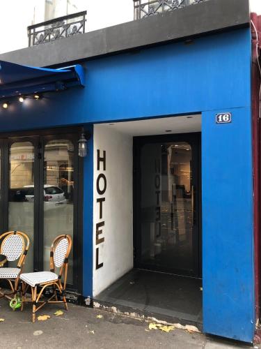 un bâtiment bleu avec deux chaises devant lui dans l'établissement Hôtel Central Bastille, à Paris