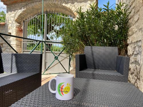 a coffee cup sitting on a table on a patio at Village de gites Mas de la Bastide in Joyeuse