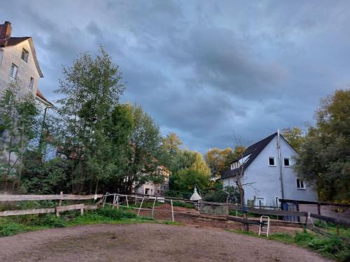 a farm with a white barn and a white house at Schöne Wohnung direkt am Bach in Neunkirchen am Sand