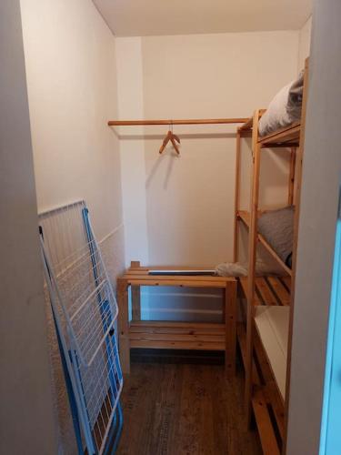 a room with two bunk beds and a desk at Schöne Wohnung direkt am Bach in Neunkirchen am Sand