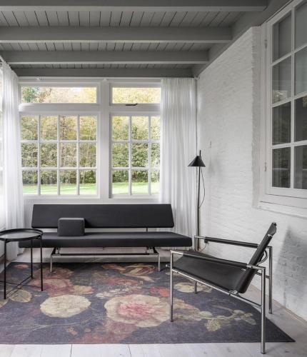 a living room with a couch and a table at Het Witte Kasteel in Loon op Zand