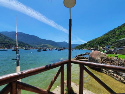 a view of a river from a wooden railing at A Casa da Ilha de Itacuruçá - Aps in Flecheiras