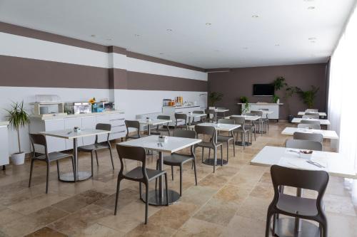 a restaurant with tables and chairs in a room at The Florence Hills Resort & Wellness in Pelago