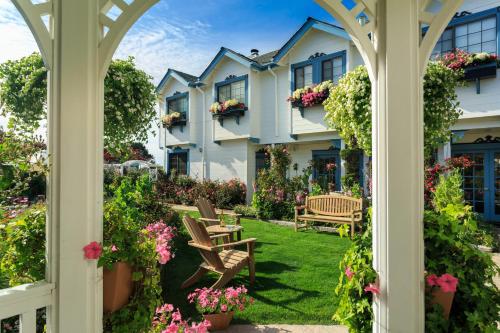 a view from the porch of a house with flowers at Mill Rose Inn in Half Moon Bay