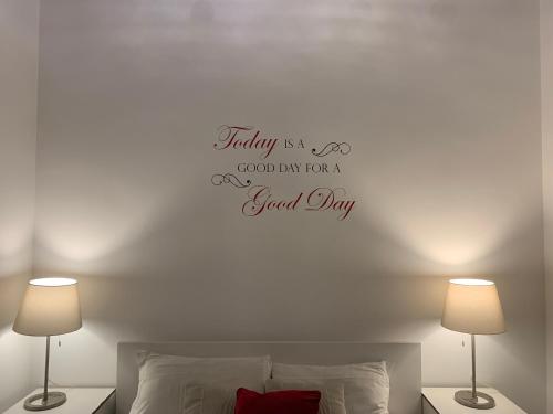 a bedroom with a bed with a happy anniversary sticker on the wall at B&S Suite Colosseo in Rome