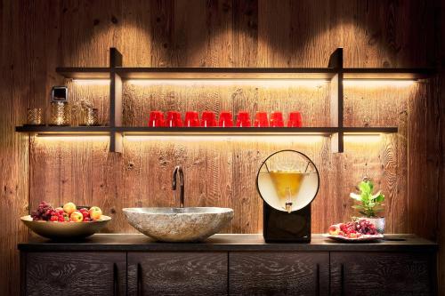 a counter with a bowl of fruit and a mixer at Sporthotel Ellmau in Tirol in Ellmau