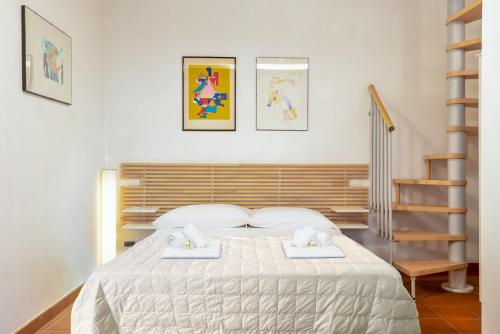 a bedroom with a bed with two white towels at Sunset Lovers, Terre Marine in San Bernardino