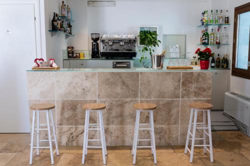 a kitchen with two bar stools and a counter at The Florence Hills Resort & Wellness in Pelago