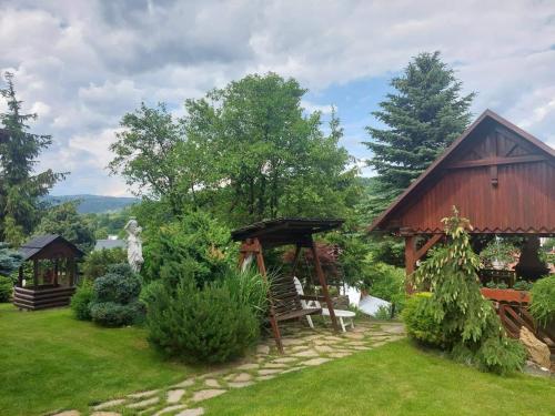 a garden with a pavilion and a gazebo at PENZIÓN U JANOSIKA in Terchová