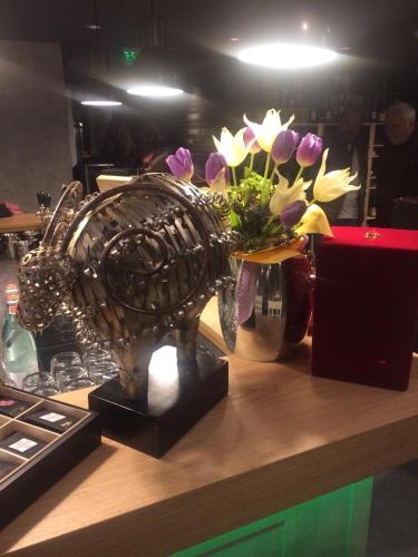 a statue of a bird on a counter with flowers at All Seasons Residence Design Hotel - Free parking in Sofia
