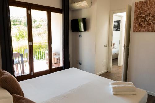 a bedroom with a bed and a view of a balcony at The Florence Hills Resort & Wellness in Pelago