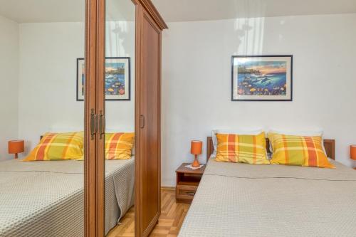 sypialnia z dwoma łóżkami i lustrem w obiekcie Apartments Azra w Puli