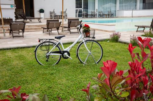 a bike parked in the grass next to a pool at The Florence Hills Resort & Wellness in Pelago