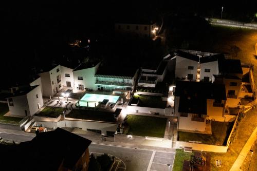 an aerial view of some buildings at night at The Florence Hills Resort & Wellness in Pelago