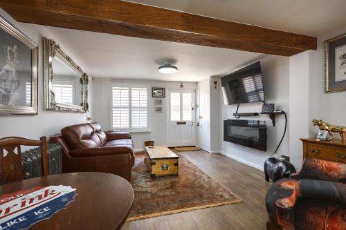 a living room with a couch and a table at Georgina in Lavenham