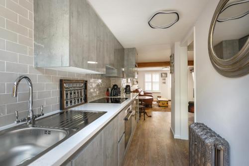 a kitchen with a sink and a counter top at Georgina in Lavenham